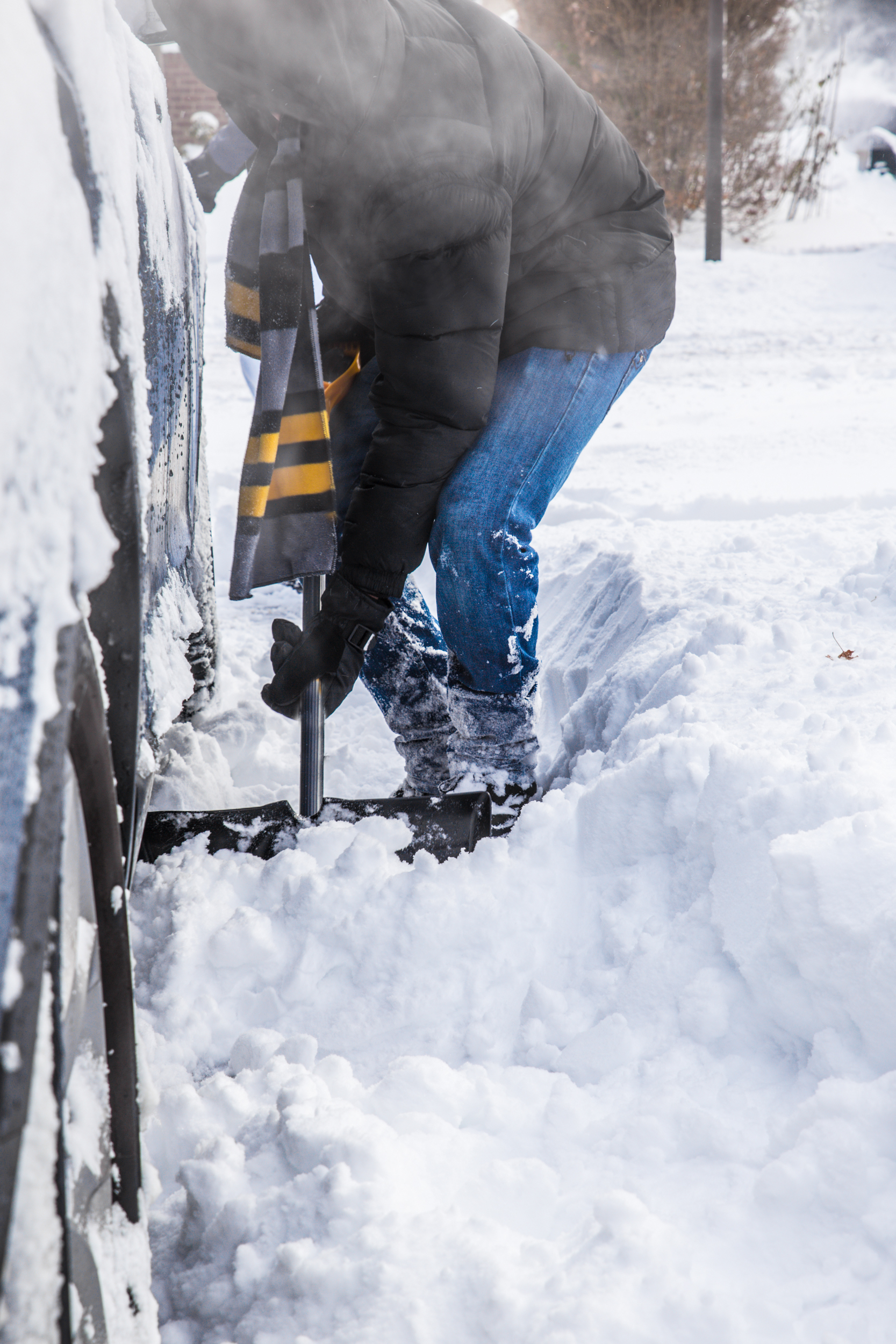 man holding shovel to remove snow
